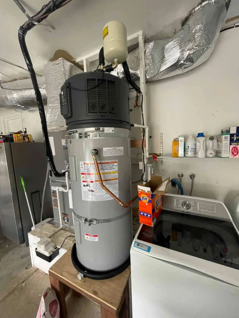 A water heater with attached pipes is installed next to a washing machine in a utility room, with detergent boxes and cleaning supplies neatly arranged on shelves nearby, creating the perfect scene for any home organization photo gallery.