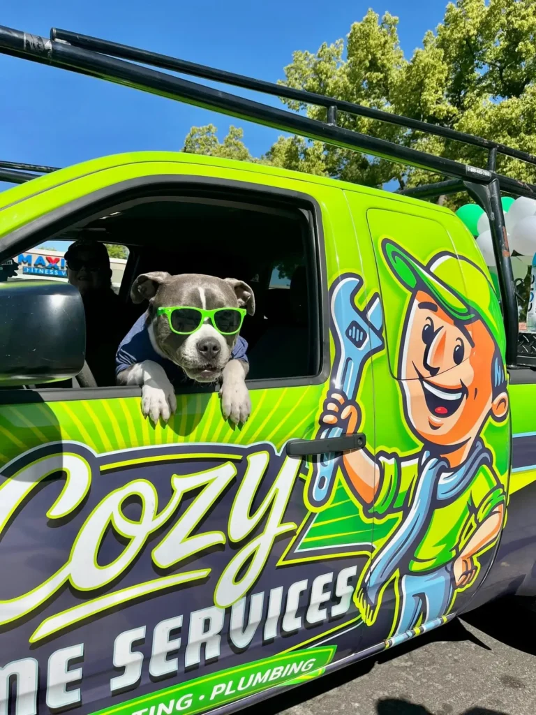 A photo gallery features a dog wearing green sunglasses, leaning out of the window of a green service truck with a cartoon handyman graphic on the door.
